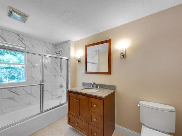 full bathroom with vanity, tile patterned floors, toilet, and combined bath / shower with glass door