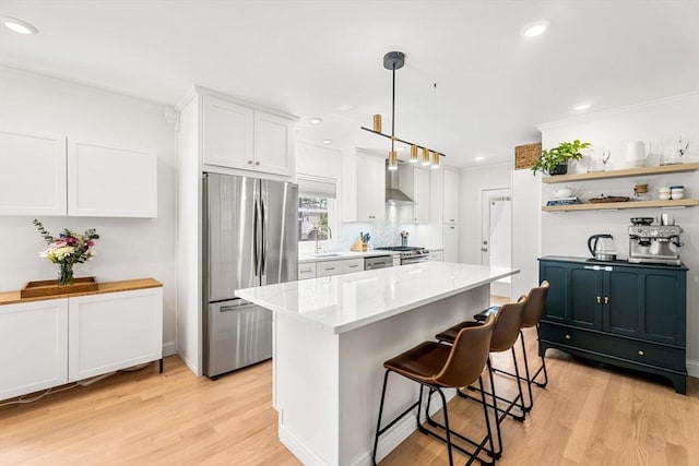 172 Orchard St Unit 172, Watertown, MA 02472 - kitchen with appliances with stainless steel finishes, a sink, light wood-style floors, crown molding, and white cabinets