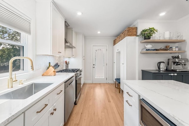 172 Orchard St Unit 172, Watertown, MA 02472 - kitchen with a sink, wall chimney exhaust hood, white cabinets, light wood-type flooring, and recessed lighting