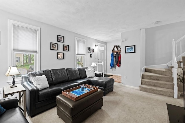 119 Wellman Ave Unit 119, Chelmsford, MA 01863 - living room featuring stairway, light colored carpet, and baseboards