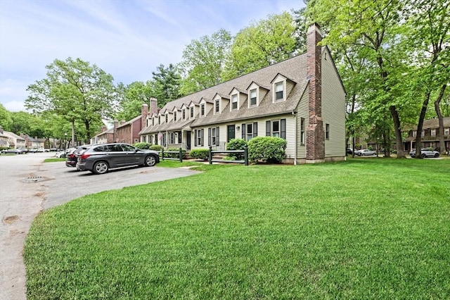 119 Wellman Ave Unit 119, Chelmsford, MA 01863 - cape cod-style house with a front yard, a shingled roof, a chimney, and uncovered parking