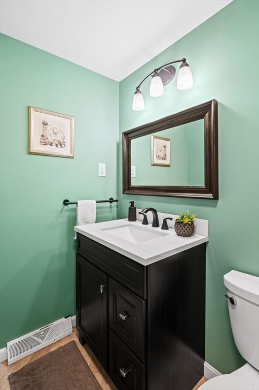 119 Wellman Ave Unit 119, Chelmsford, MA 01863 - half bath with vanity, baseboards, and toilet