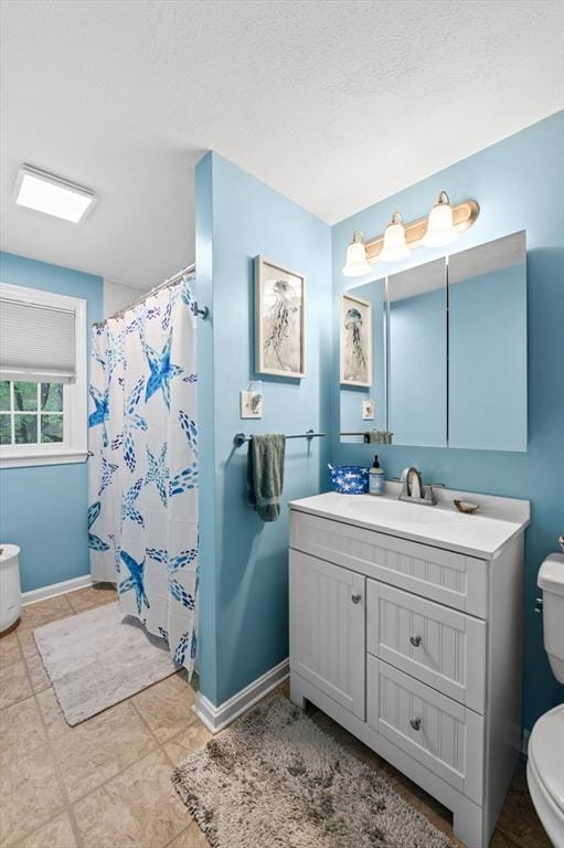 119 Wellman Ave Unit 119, Chelmsford, MA 01863 - bathroom featuring toilet, vanity, baseboards, a shower with curtain, and a textured ceiling