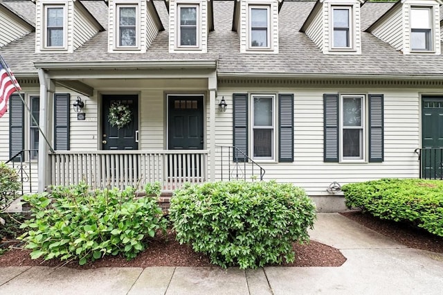 119 Wellman Ave Unit 119, Chelmsford, MA 01863 - view of exterior entry featuring roof with shingles and covered porch
