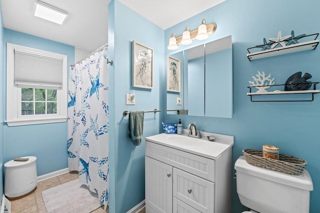 119 Wellman Ave Unit 119, Chelmsford, MA 01863 - bathroom with toilet, vanity, baseboards, and curtained shower