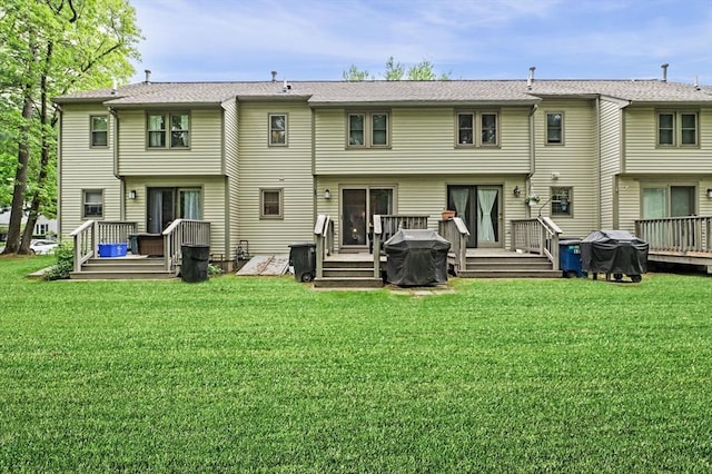 119 Wellman Ave Unit 119, Chelmsford, MA 01863 - back of property featuring a deck and a lawn