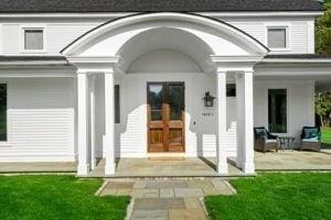doorway to property featuring a yard and a porch