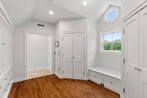 mudroom with lofted ceiling, wood finished floors, and recessed lighting
