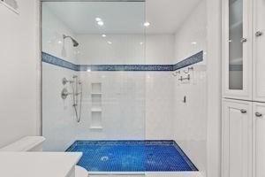 full bath with a walk in shower and toilet