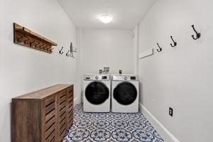 laundry room with washer and dryer and baseboards