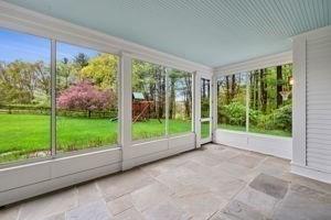 unfurnished sunroom featuring plenty of natural light