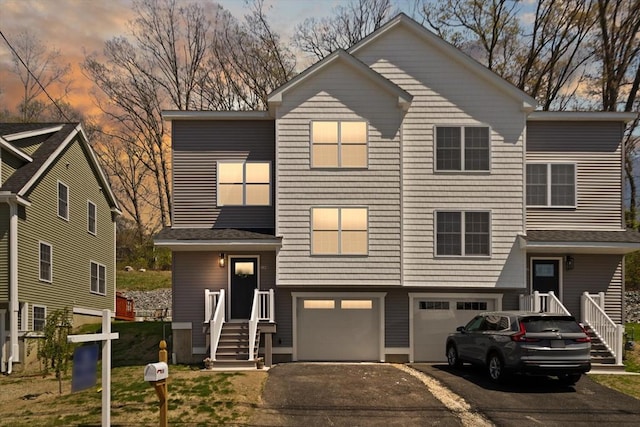 view of front of home featuring a garage and aphalt driveway