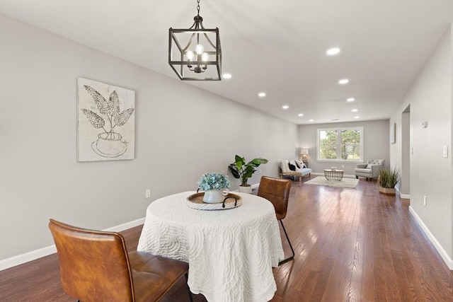 dining area featuring wood-type flooring, recessed lighting, baseboards, and a chandelier