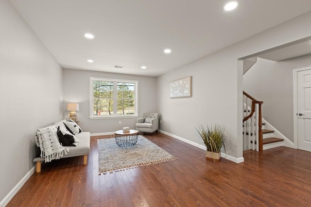 living area featuring recessed lighting, baseboards, stairs, and wood finished floors