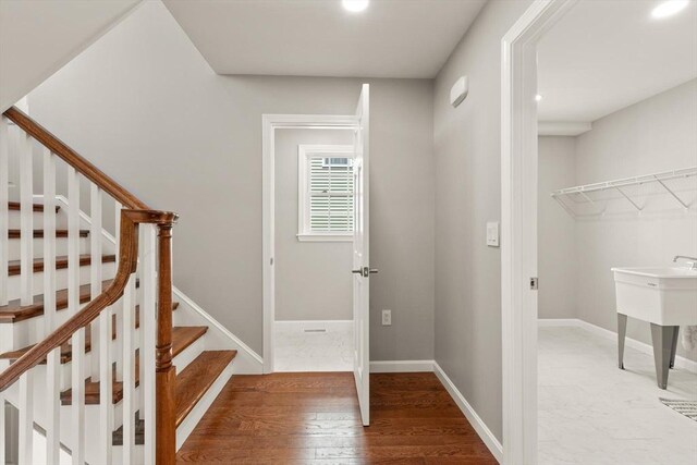 stairway with recessed lighting, baseboards, and wood finished floors