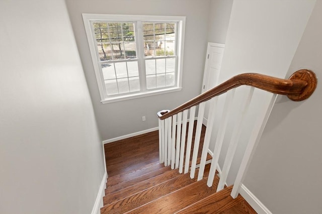 stairs featuring baseboards and wood finished floors