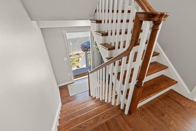stairs featuring baseboards and wood finished floors