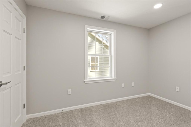 empty room with carpet flooring, recessed lighting, baseboards, and visible vents