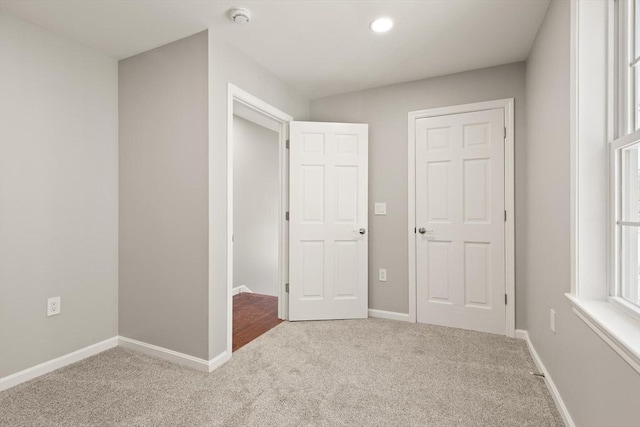 unfurnished bedroom with baseboards, recessed lighting, and carpet