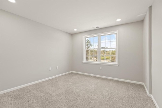 empty room with baseboards, carpet, and recessed lighting