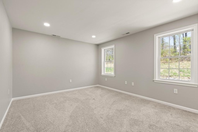 carpeted empty room with baseboards and a healthy amount of sunlight