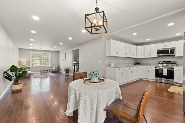 dining room with recessed lighting, baseboards, dark wood-style floors, and a notable chandelier