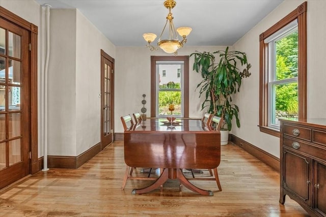100 Williams Ave, Boston, MA 02136 - dining space with light wood finished floors, french doors, and a chandelier