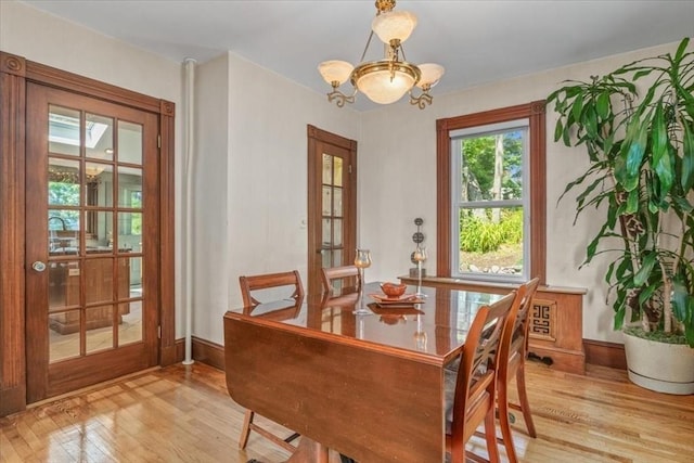 100 Williams Ave, Boston, MA 02136 - dining room featuring light wood-type flooring, a chandelier, and french doors