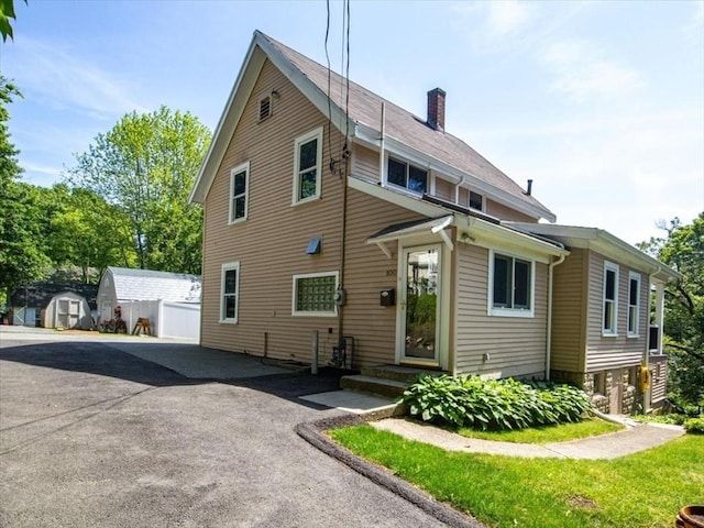 100 Williams Ave, Boston, MA 02136 - view of front of house featuring a chimney and an outdoor structure