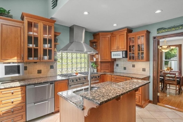 100 Williams Ave, Boston, MA 02136 - kitchen with wall chimney range hood, white microwave, light tile patterned floors, brown cabinets, and recessed lighting