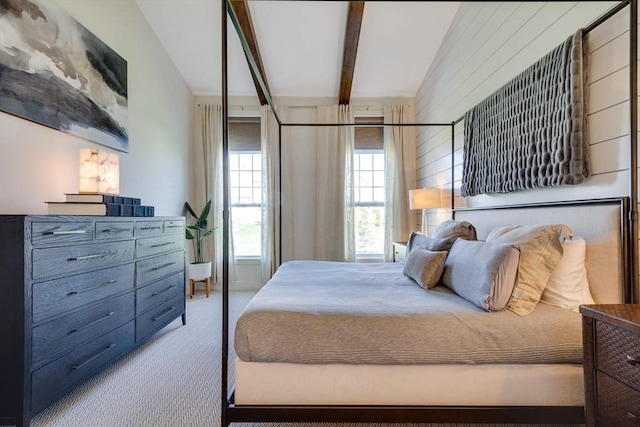 carpeted bedroom with beamed ceiling
