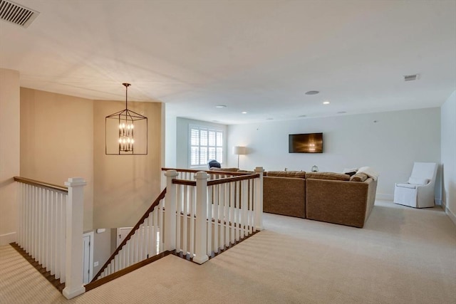 interior space with visible vents, carpet flooring, and an upstairs landing