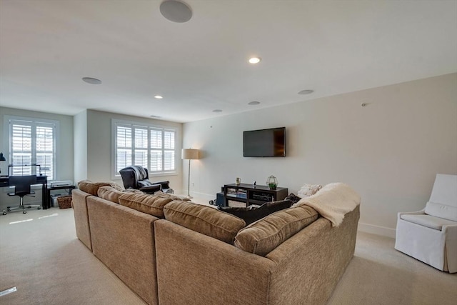 living area with recessed lighting, baseboards, and light carpet