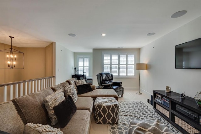 living room with baseboards and a chandelier