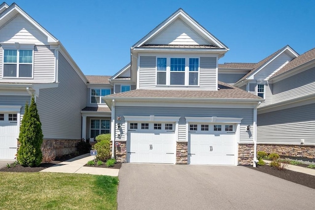 craftsman-style house with roof with shingles, an attached garage, stone siding, and aphalt driveway