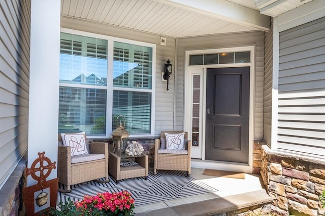doorway to property with covered porch and stone siding