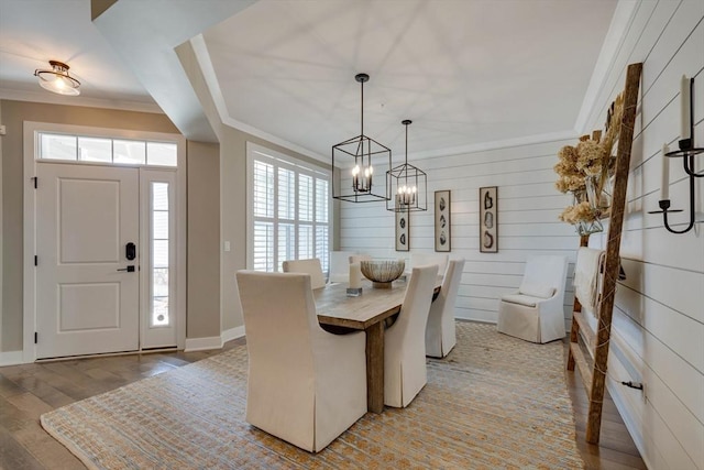 dining space featuring crown molding, baseboards, an inviting chandelier, and plenty of natural light
