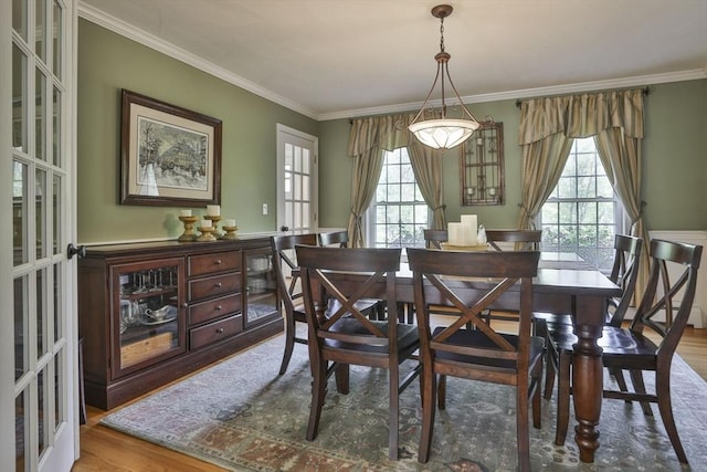dining room featuring wood finished floors and ornamental molding
