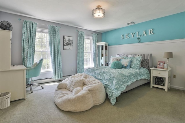 carpeted bedroom with a baseboard radiator and baseboards
