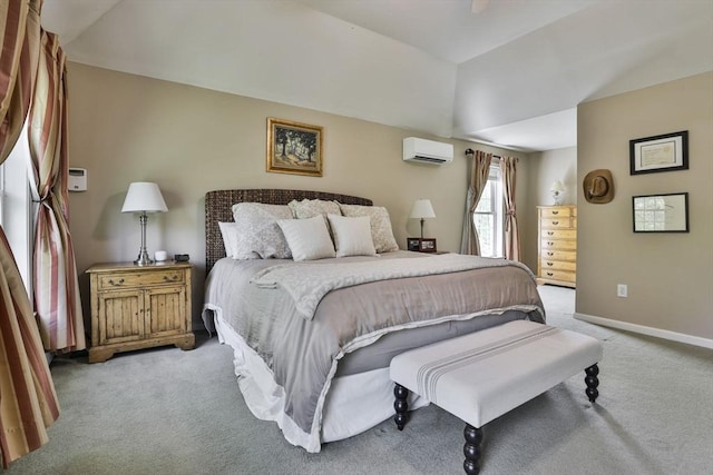 bedroom featuring light carpet, a wall mounted AC, baseboards, and vaulted ceiling