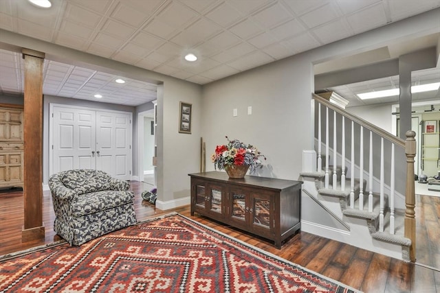 sitting room featuring hardwood / wood-style flooring, recessed lighting, baseboards, and stairs