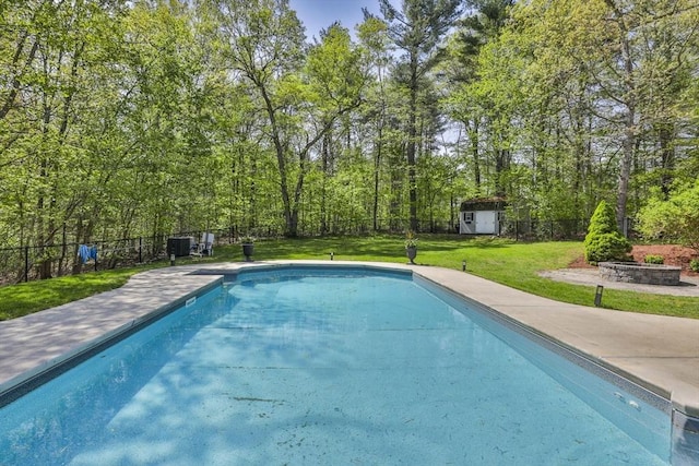 swimming pool featuring a shed and an outdoor structure