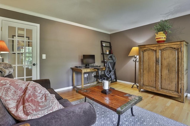 living area featuring light wood-style flooring, baseboards, ornamental molding, and an office area