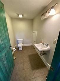 bathroom featuring tile patterned flooring and toilet