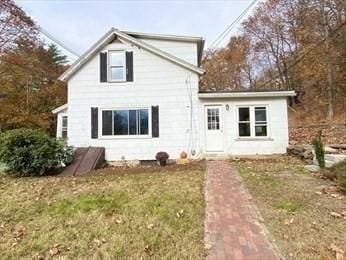 rear view of house with a lawn