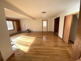 interior space with beamed ceiling and hardwood / wood-style flooring