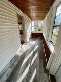 unfurnished sunroom featuring wooden ceiling