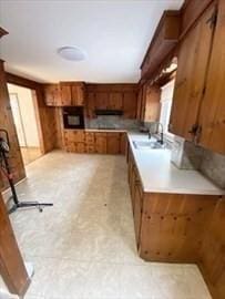 kitchen with wood walls, sink, and extractor fan