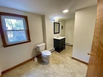 bathroom with vanity, a baseboard radiator, and toilet