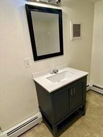 bathroom featuring baseboard heating and vanity